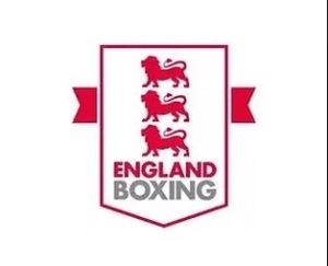 The England Boxing logo features three red lions stacked vertically above the words England Boxing in red and grey, all within a red-bordered shield on a white background. Red banners extend from both sides of the shield.